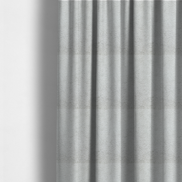 The fabric used to create these made-to-measure curtains features a high-pile faux fur texture that offers a cool-toned, plush aesthetic with a rich tactile quality.
