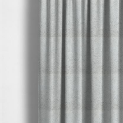 The fabric used to create these made-to-measure curtains features a high-pile faux fur texture that offers a cool-toned, plush aesthetic with a rich tactile quality.