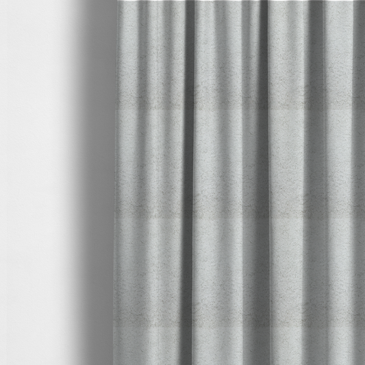 The fabric used to create these made-to-measure curtains features a high-pile faux fur texture that offers a cool-toned, plush aesthetic with a rich tactile quality.