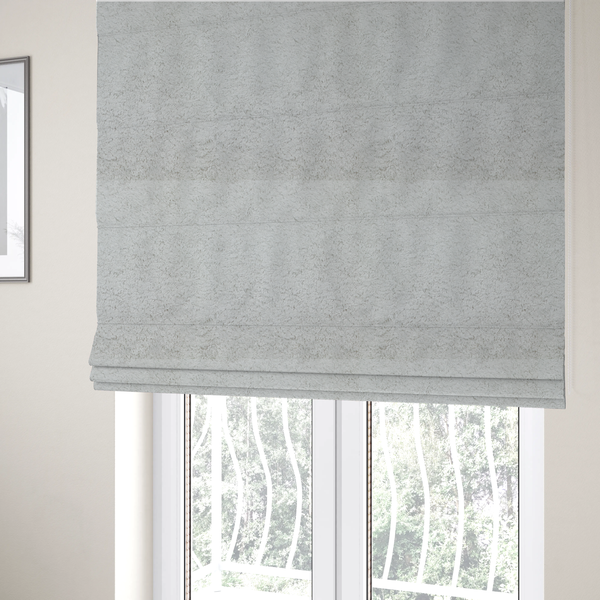 The fabric used to create these Roman blinds features a high-pile faux fur texture that offers a cool-toned, plush aesthetic with a rich tactile quality.