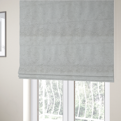 The fabric used to create these Roman blinds features a high-pile faux fur texture that offers a cool-toned, plush aesthetic with a rich tactile quality.