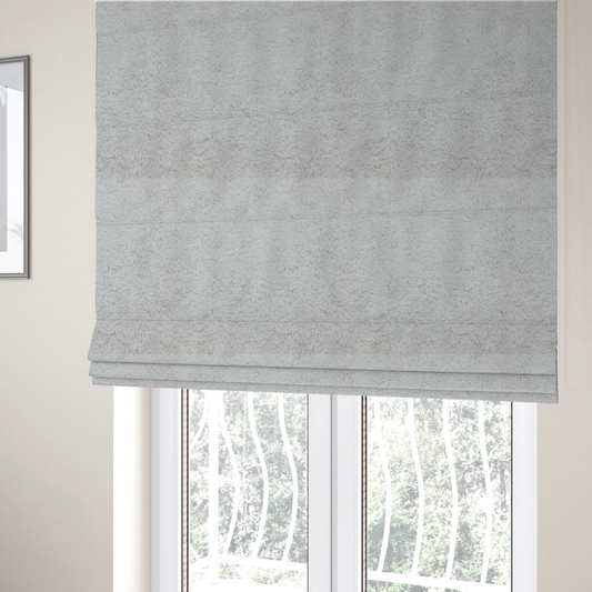 The fabric used to create these Roman blinds features a high-pile faux fur texture that offers a cool-toned, plush aesthetic with a rich tactile quality.