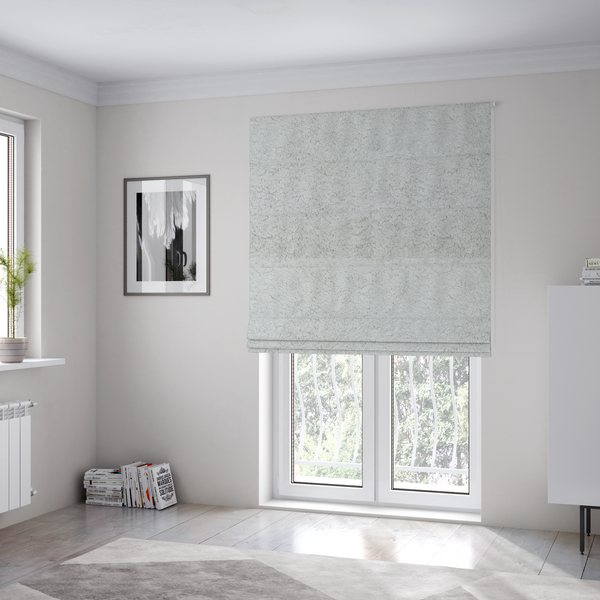 The fabric used to create these Roman blinds features a high-pile faux fur texture that offers a cool-toned, plush aesthetic with a rich tactile quality.