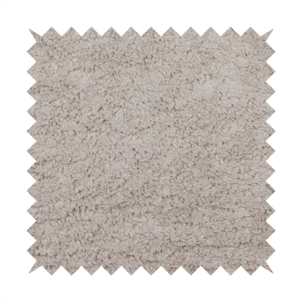This fabric features a high-pile faux fur texture that offers a warm, neutral aesthetic with a soft and tactile quality.