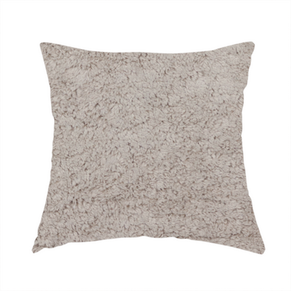 The fabric used to create these handmade cushions features a high-pile faux fur texture that offers a warm, neutral aesthetic with a soft and tactile quality.