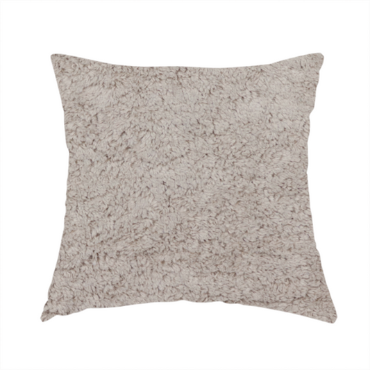The fabric used to create these handmade cushions features a high-pile faux fur texture that offers a warm, neutral aesthetic with a soft and tactile quality.