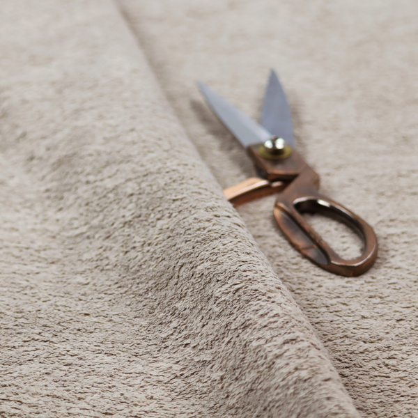 This fabric features a high-pile faux fur texture that offers a warm, neutral aesthetic with a soft and tactile quality.