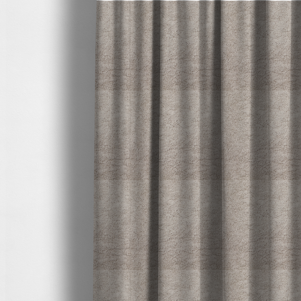 The fabric used to create these made-to-measure curtains features a high-pile faux fur texture that offers a warm, neutral aesthetic with a soft and tactile quality.