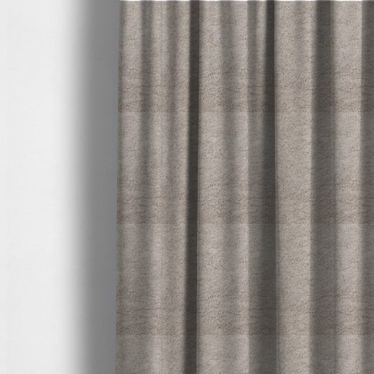 The fabric used to create these made-to-measure curtains features a high-pile faux fur texture that offers a warm, neutral aesthetic with a soft and tactile quality.