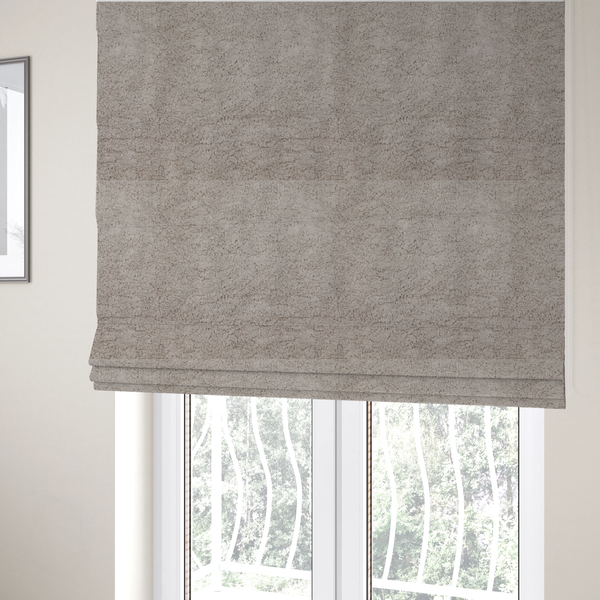 The fabric used to create these Roman blinds features a high-pile faux fur texture that offers a warm, neutral aesthetic with a soft and tactile quality.