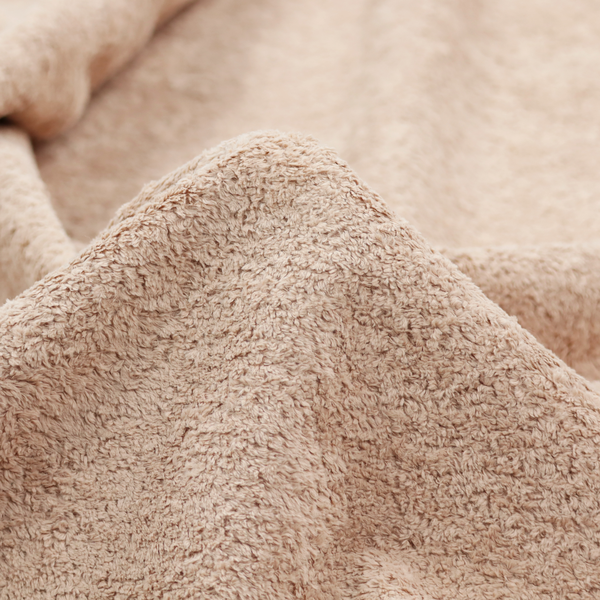This fabric features a high-pile faux fur texture that offers a warm, inviting aesthetic with a soft and tactile quality.