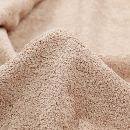 This fabric features a high-pile faux fur texture that offers a warm, inviting aesthetic with a soft and tactile quality.