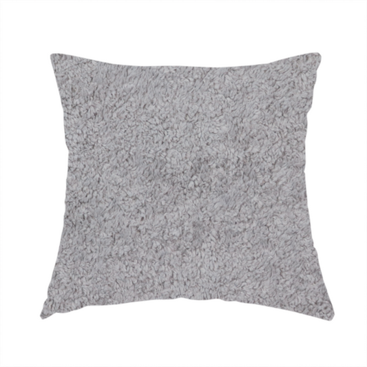 The fabric used to create this handmade cushion features a high-pile faux fur texture that offers a sophisticated, cool-neutral aesthetic with a soft and tactile quality.
