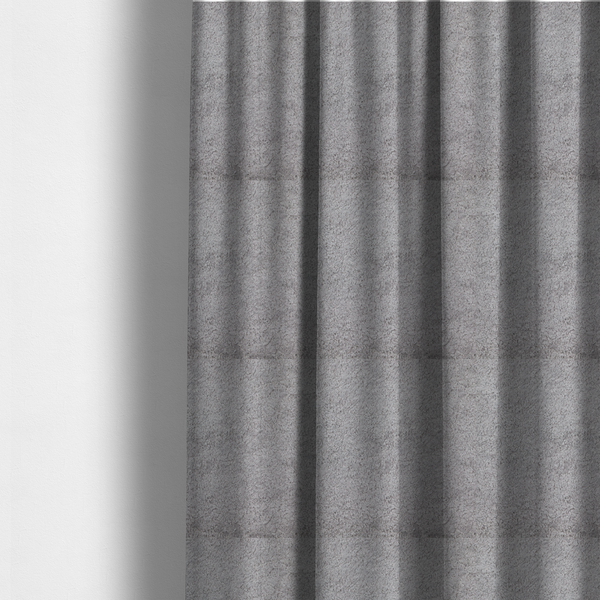 The fabric used to create these made-to-measure curtains features a high-pile faux fur texture that offers a sophisticated, cool-neutral aesthetic with a soft and tactile quality.