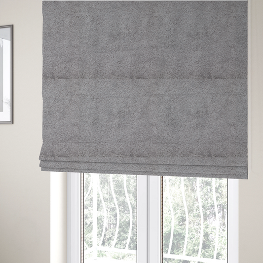 The fabric used to create these Roman blinds features a high-pile faux fur texture that offers a sophisticated, cool-neutral aesthetic with a soft and tactile quality.