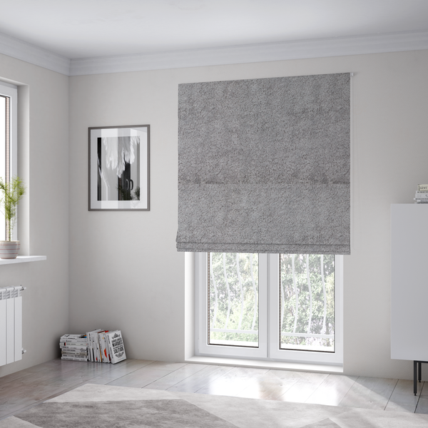 The fabric used to create these Roman blinds features a high-pile faux fur texture that offers a sophisticated, cool-neutral aesthetic with a soft and tactile quality.