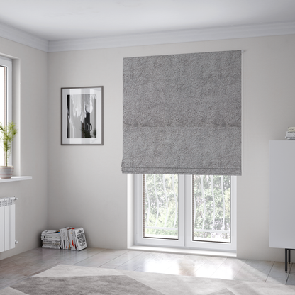 The fabric used to create these Roman blinds features a high-pile faux fur texture that offers a sophisticated, cool-neutral aesthetic with a soft and tactile quality.