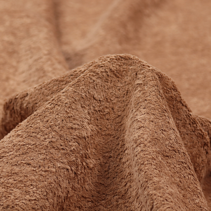 This fabric features a high-pile faux fur texture that provides a rich, earthy aesthetic with a soft and plush tactile quality.