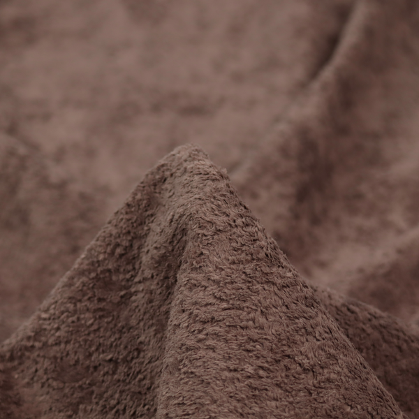 This fabric features a high-pile faux fur texture that offers a deep, grounded aesthetic with a soft and plush tactile quality.