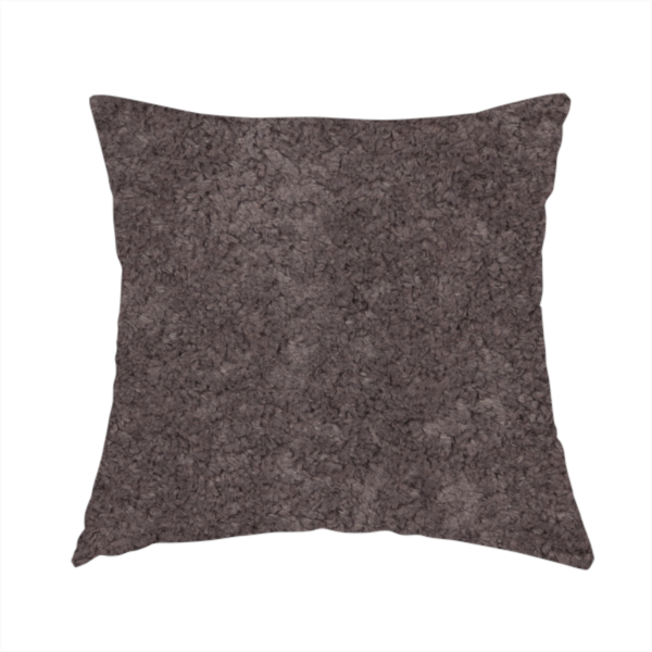 The fabric used to create this handmade cushion features a high-pile faux fur texture that offers a deep, moody aesthetic with a soft and plush tactile quality.