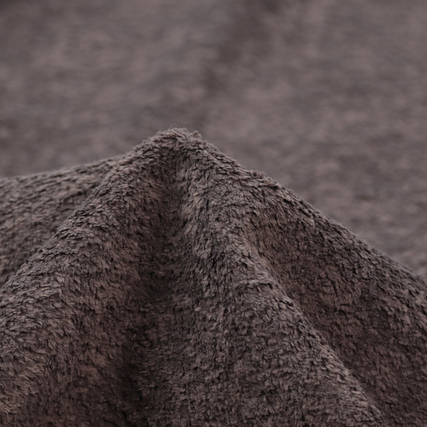 This fabric features a high-pile faux fur texture that offers a deep, moody aesthetic with a soft and plush tactile quality.