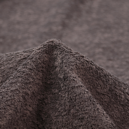 This fabric features a high-pile faux fur texture that offers a deep, moody aesthetic with a soft and plush tactile quality.