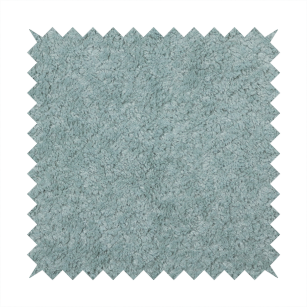 A soft, textured fabric in a muted, calming shade of blue. The surface features a dense, uniform, and plush pile texture.