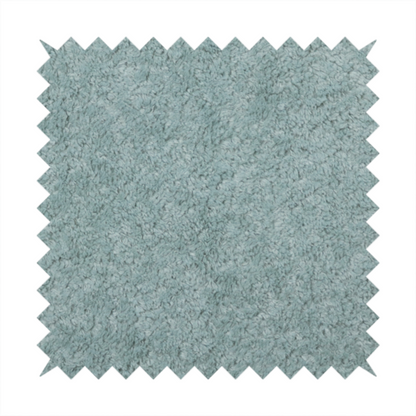 A soft, textured fabric in a muted, calming shade of blue. The surface features a dense, uniform, and plush pile texture.