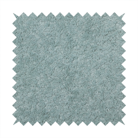 A soft, textured fabric in a muted, calming shade of blue. The surface features a dense, uniform, and plush pile texture.