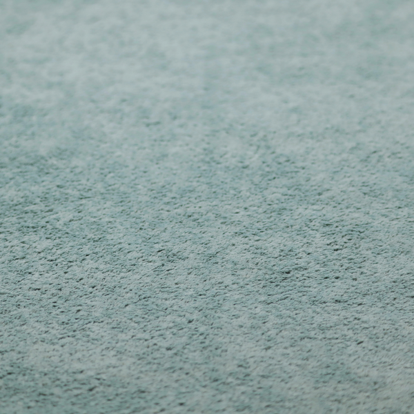 A soft, textured fabric in a muted, calming shade of blue. The surface features a dense, uniform, and plush pile texture.