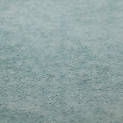 A soft, textured fabric in a muted, calming shade of blue. The surface features a dense, uniform, and plush pile texture.