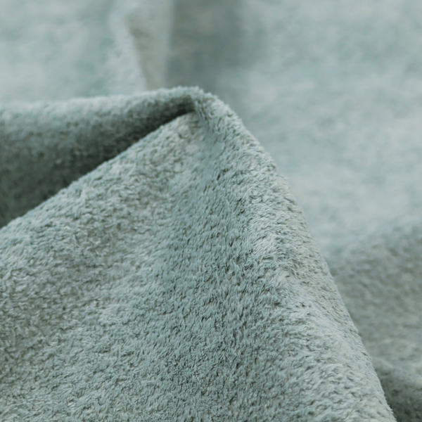 A soft, textured fabric in a muted, calming shade of blue. The surface features a dense, uniform, and plush pile texture.