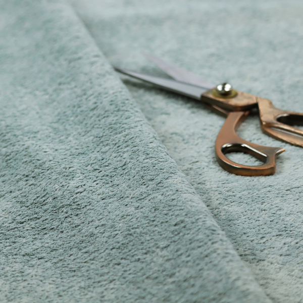 A soft, textured fabric in a muted, calming shade of blue. The surface features a dense, uniform, and plush pile texture.