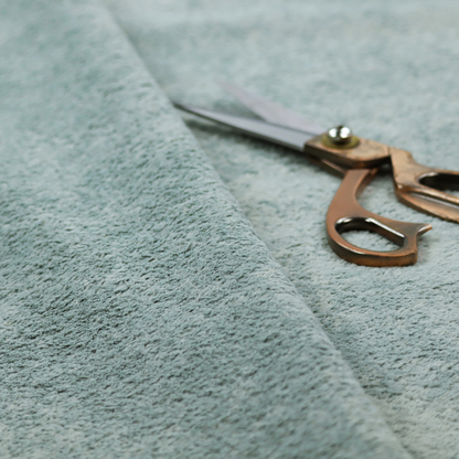 A soft, textured fabric in a muted, calming shade of blue. The surface features a dense, uniform, and plush pile texture.