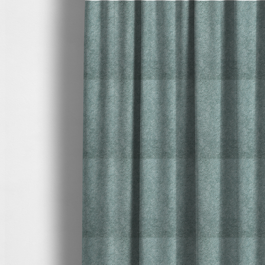 The fabric used to create these made-to-measure curtains is a soft, textured fabric in a muted, calming shade of blue. The surface features a dense, uniform, and plush pile texture.