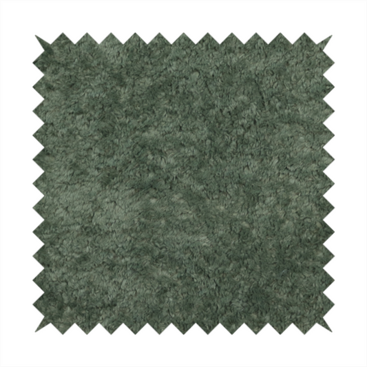 A soft, textured fabric in a rich, earthy green shade. The surface features a dense, uniform, and plush pile, characteristic of thick fleece or absorbent terry cloth material.