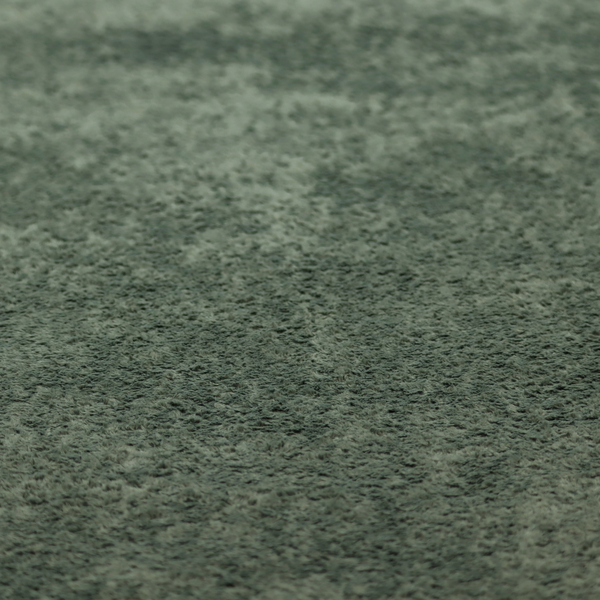A soft, textured fabric in a rich, earthy green shade. The surface features a dense, uniform, and plush pile, characteristic of thick fleece or absorbent terry cloth material.
