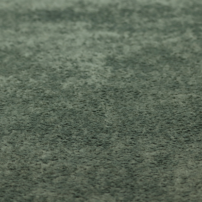 A soft, textured fabric in a rich, earthy green shade. The surface features a dense, uniform, and plush pile, characteristic of thick fleece or absorbent terry cloth material.