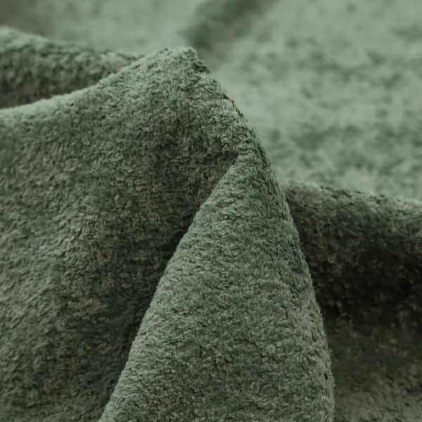A soft, textured fabric in a rich, earthy green shade. The surface features a dense, uniform, and plush pile, characteristic of thick fleece or absorbent terry cloth material.