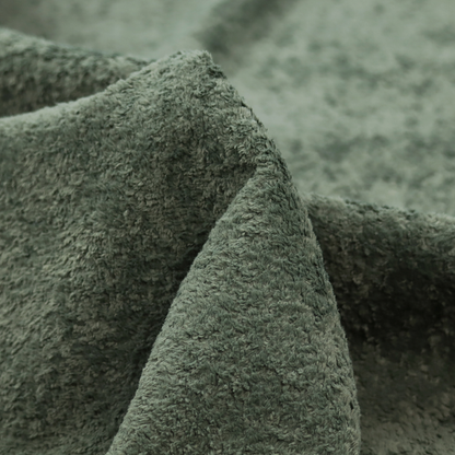 A soft, textured fabric in a rich, earthy green shade. The surface features a dense, uniform, and plush pile, characteristic of thick fleece or absorbent terry cloth material.