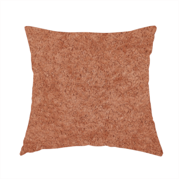 The fabric used to create this handmade cushion is a soft, textured fabric in a warm, muted terracotta or rust shade. The surface features a dense, uniform, and plush pile, characteristic of thick fleece or absorbent terry cloth material.