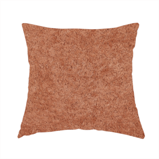 The fabric used to create this handmade cushion is a soft, textured fabric in a warm, muted terracotta or rust shade. The surface features a dense, uniform, and plush pile, characteristic of thick fleece or absorbent terry cloth material.