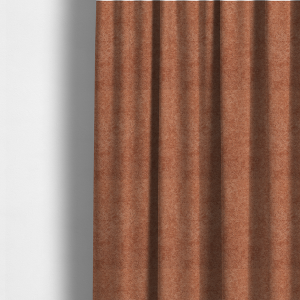 The fabric used to create these made-to-measure curtains is a soft, textured fabric in a warm, muted terracotta or rust shade. The surface features a dense, uniform, and plush pile, characteristic of thick fleece or absorbent terry cloth material.