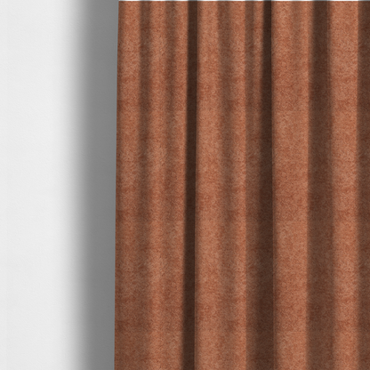 The fabric used to create these made-to-measure curtains is a soft, textured fabric in a warm, muted terracotta or rust shade. The surface features a dense, uniform, and plush pile, characteristic of thick fleece or absorbent terry cloth material.