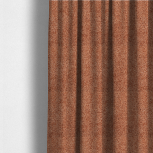 The fabric used to create these made-to-measure curtains is a soft, textured fabric in a warm, muted terracotta or rust shade. The surface features a dense, uniform, and plush pile, characteristic of thick fleece or absorbent terry cloth material.