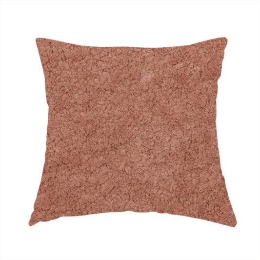 The fabric used to create this handmade cushion is a soft, textured fabric in a muted, dusty rose shade, featuring a dense, uniform, and plush pile like thick fleece or terry.