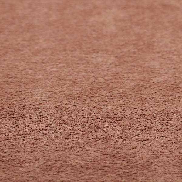 A soft, textured fabric in a muted, dusty rose shade, featuring a dense, uniform, and plush pile like thick fleece or terry.