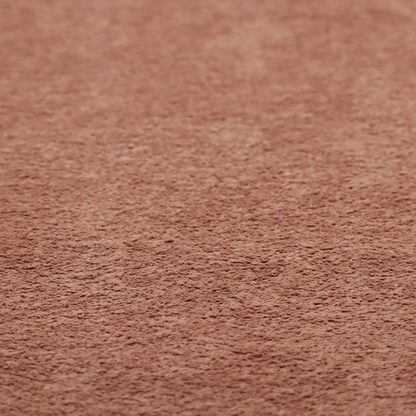 A soft, textured fabric in a muted, dusty rose shade, featuring a dense, uniform, and plush pile like thick fleece or terry.