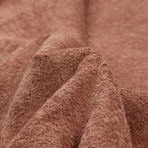 A soft, textured fabric in a muted, dusty rose shade, featuring a dense, uniform, and plush pile like thick fleece or terry.