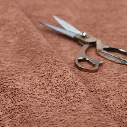 A soft, textured fabric in a muted, dusty rose shade, featuring a dense, uniform, and plush pile like thick fleece or terry.